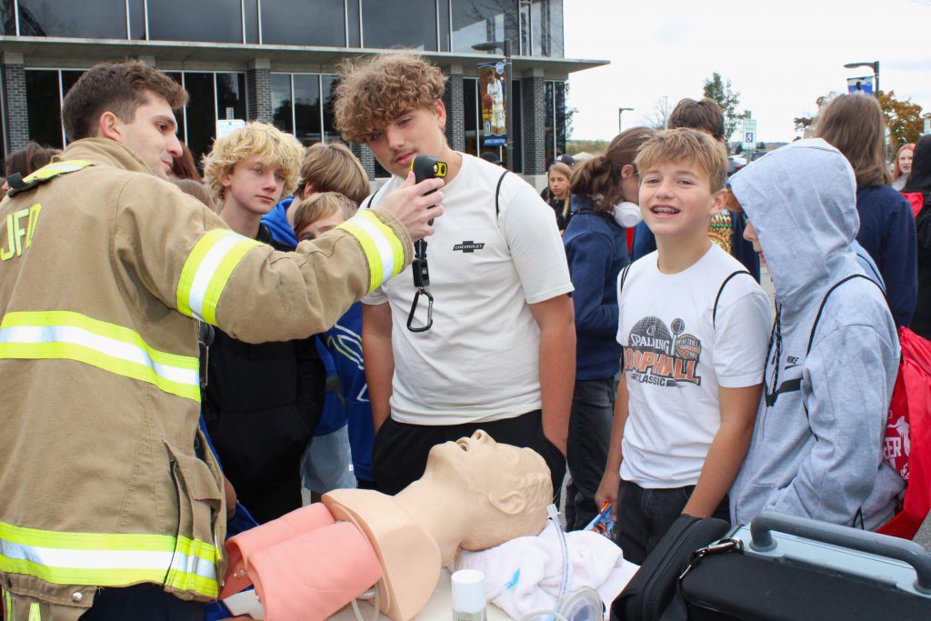 student and firefighter with human dummy