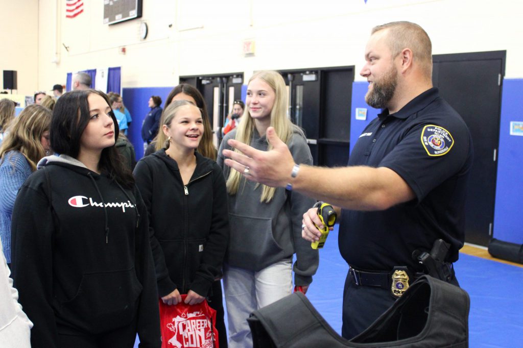 students talking with police officer