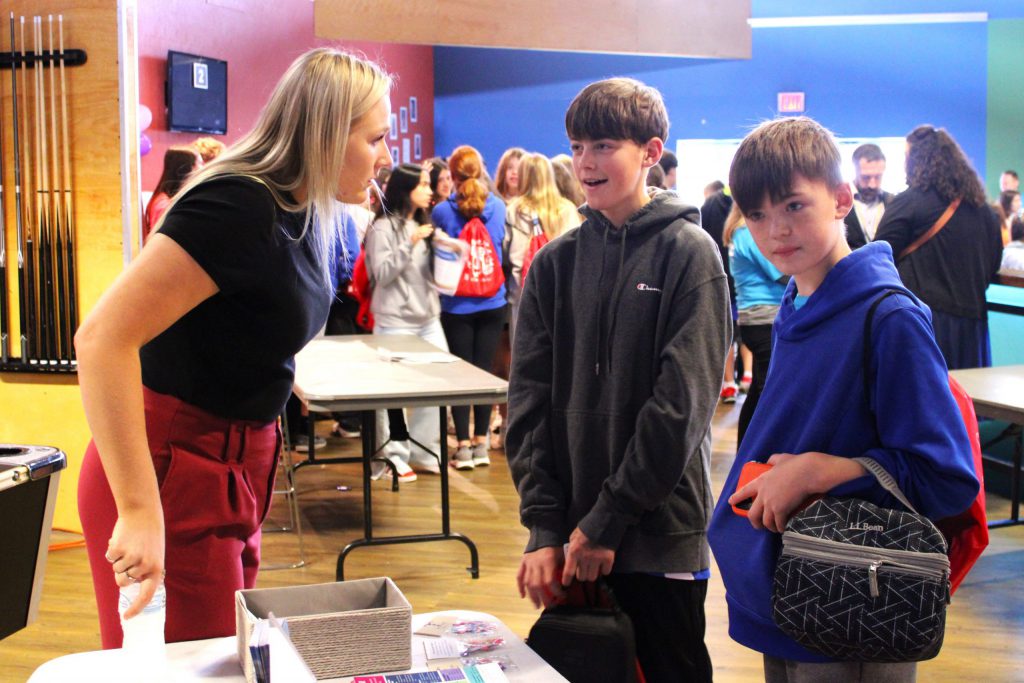 students speaking with adult