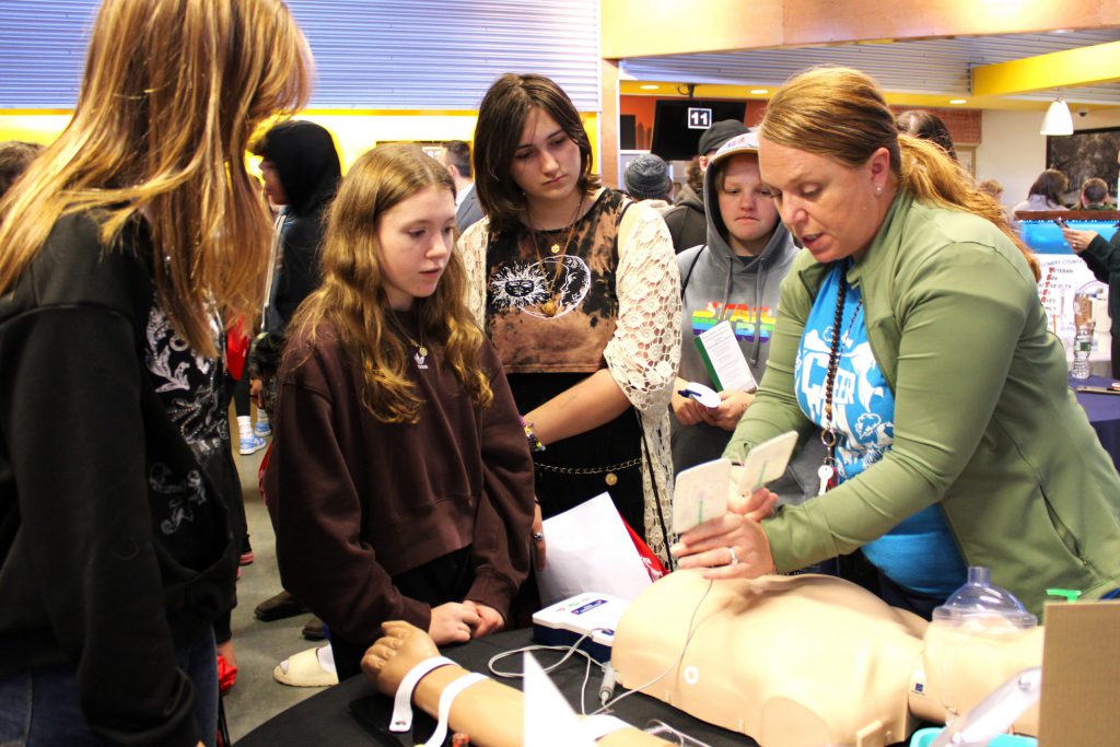 students interacting with human dummy