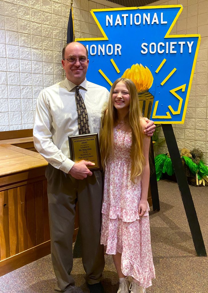 Student and teacher posing with award.