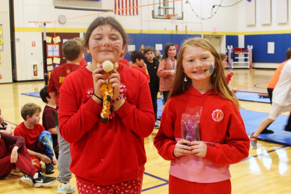 Two students with facepaint smiling