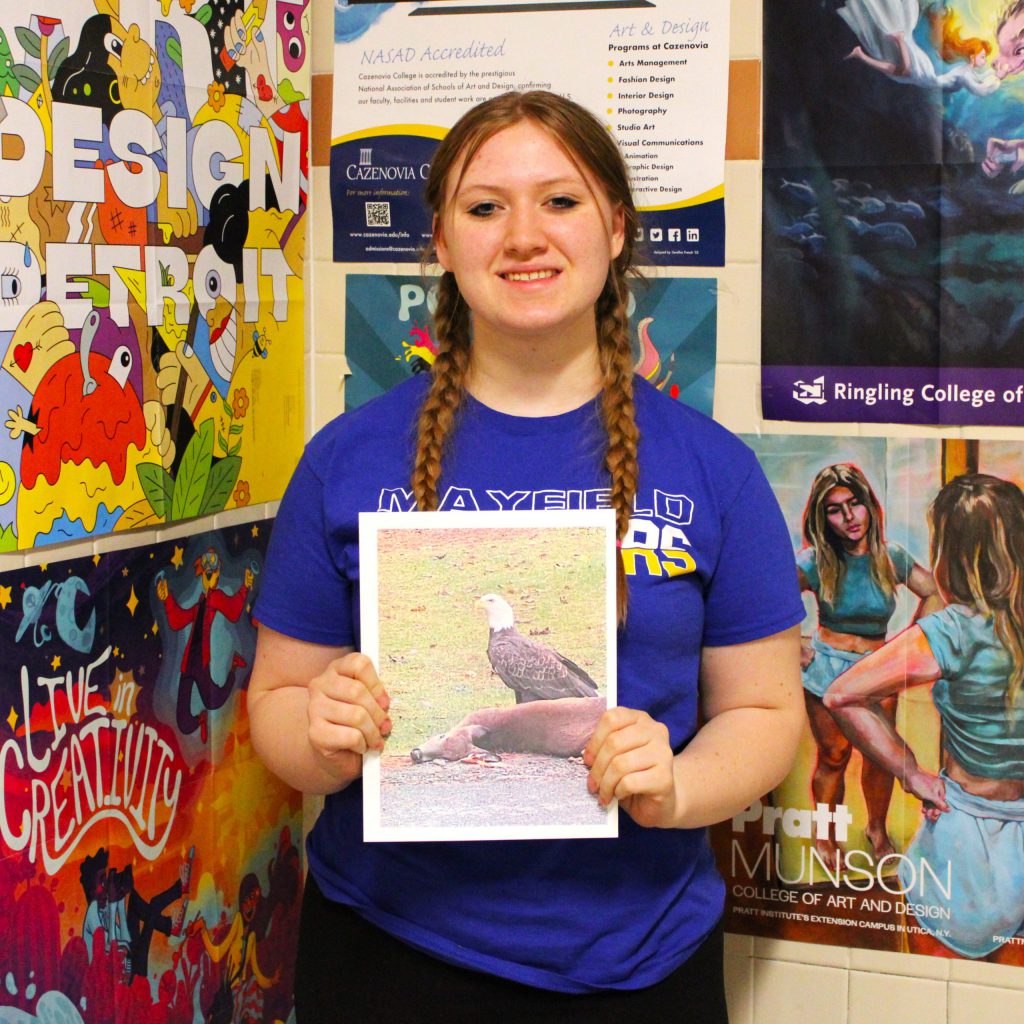 photo of student showing awards.