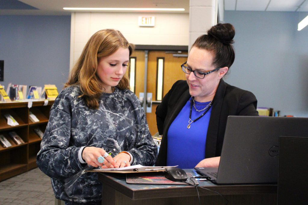 photo of teacher and student working together