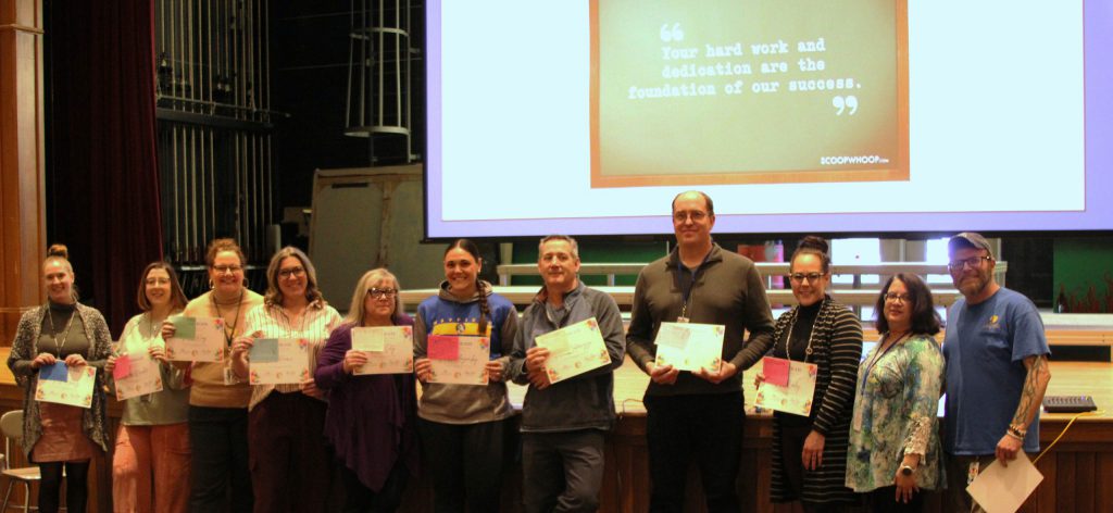 photo of students showing awards.