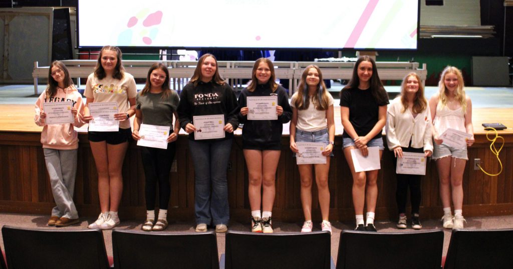 photo of students showing awards.