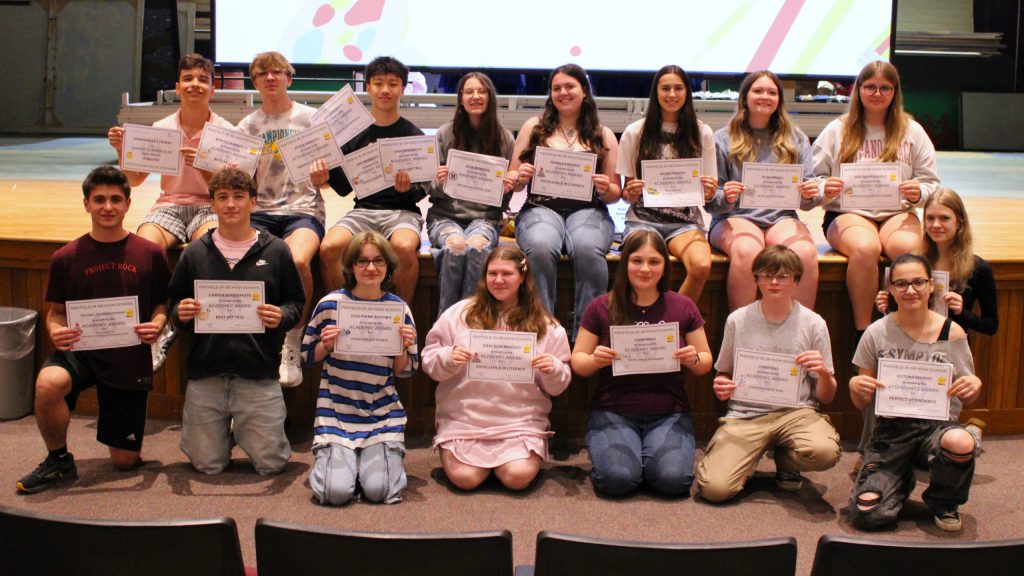 photo of students showing awards.
