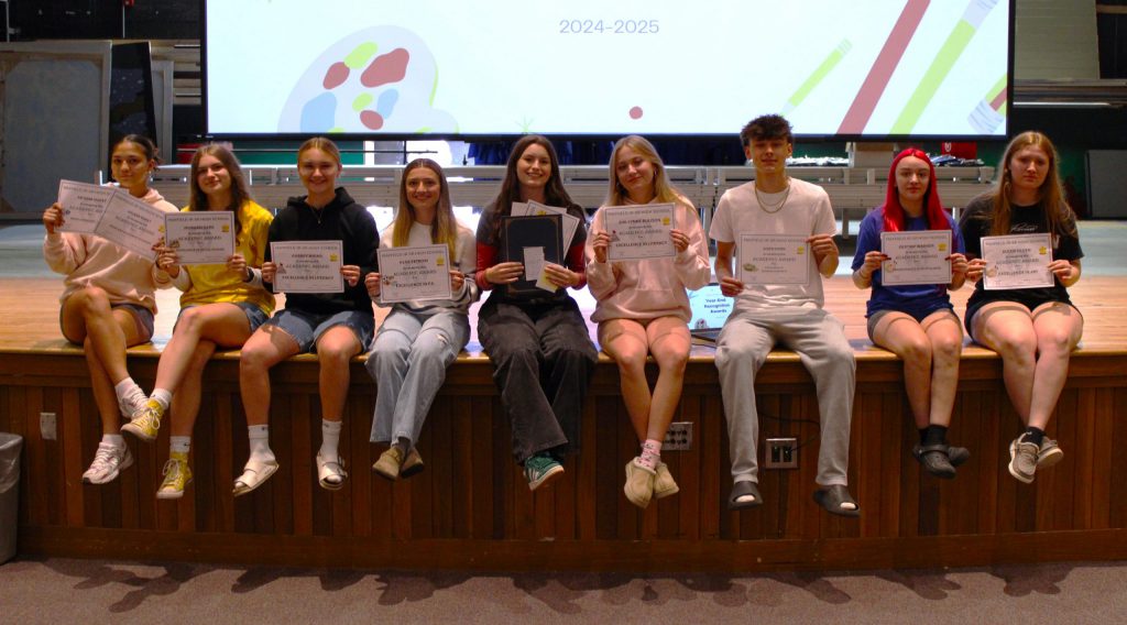 photo of students showing awards.