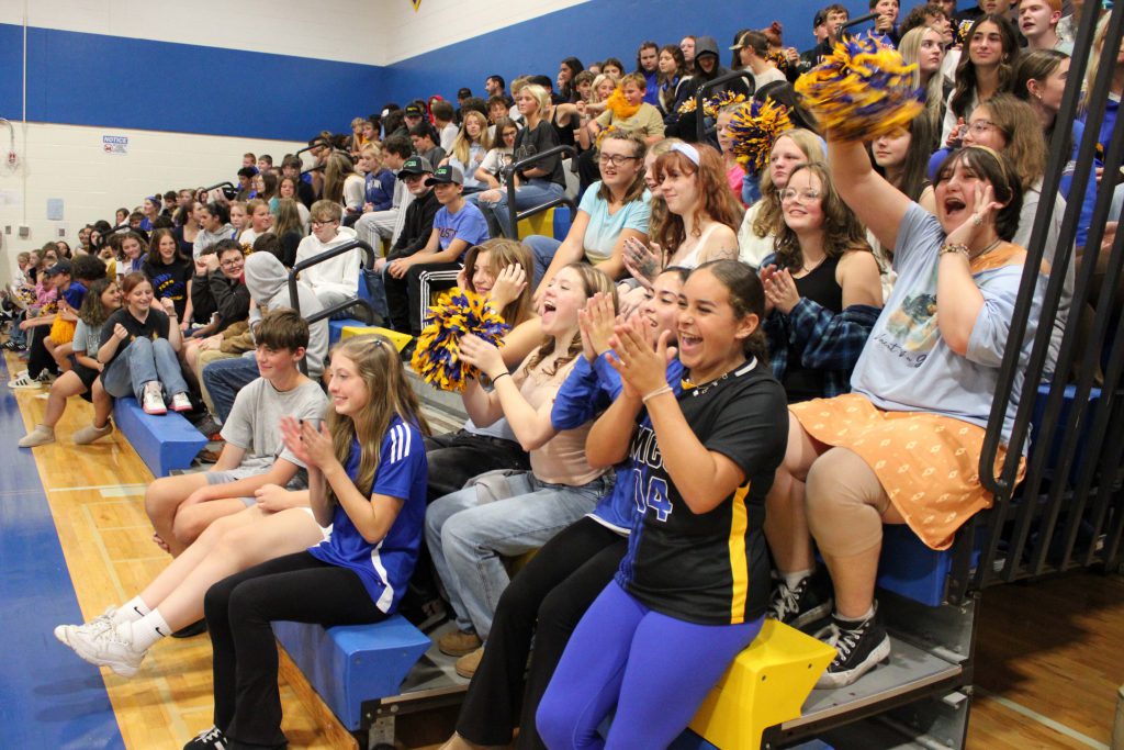 students cheering from bleachers