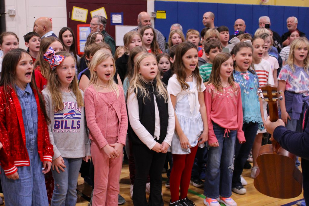 students standing in rows singing