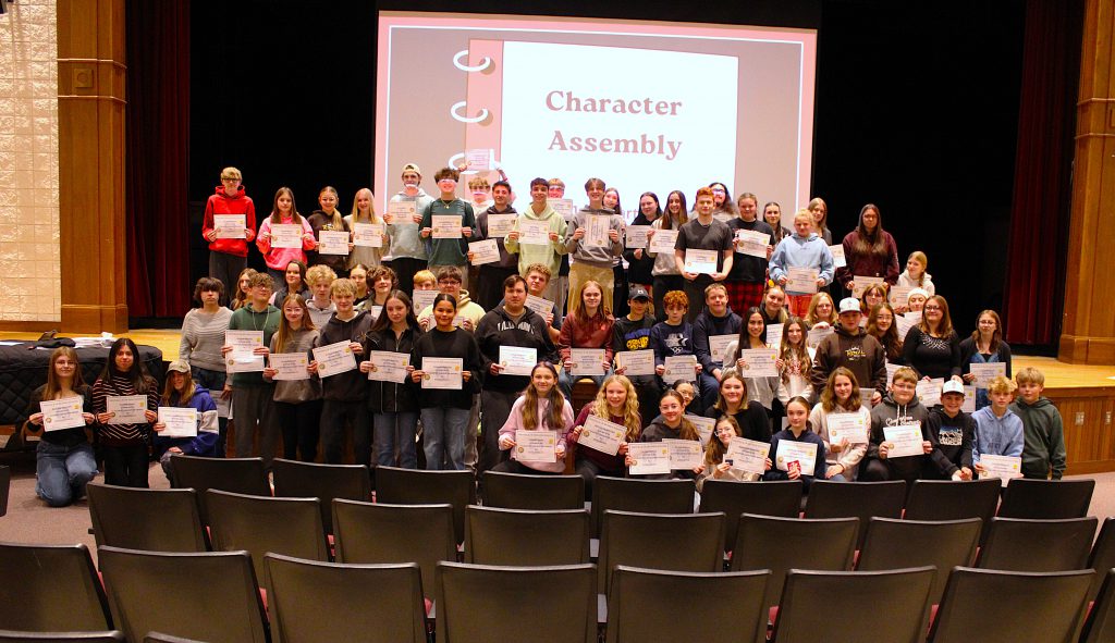 three rows of students hold certificates