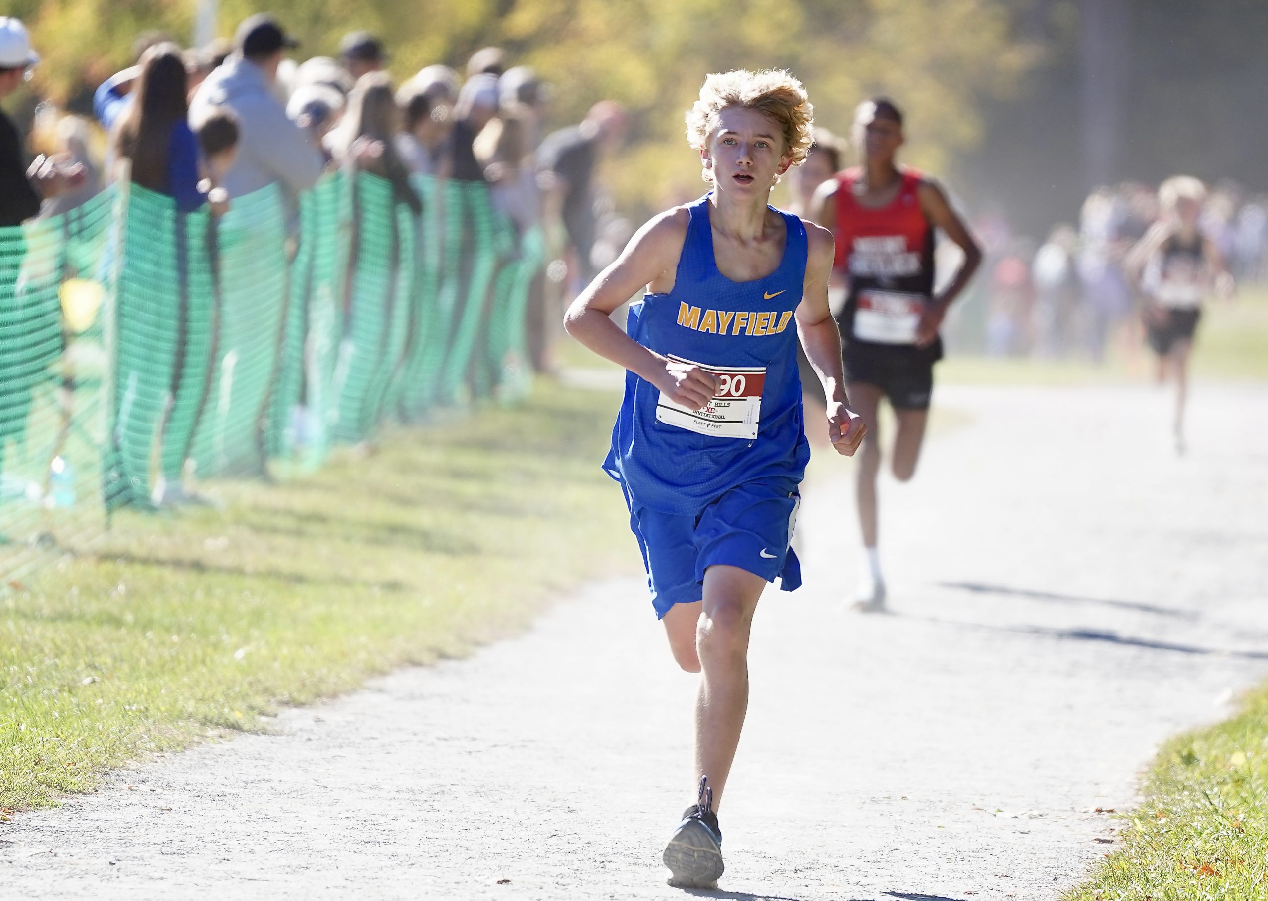 person running in blue Mayfield uniform will people cheer on