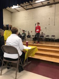Student speaks into microphone during bee